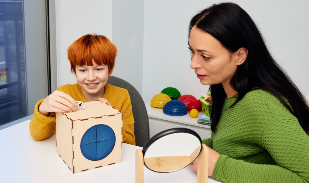 A speech therapist uses a play-based activity to support a child’s communication and language development.