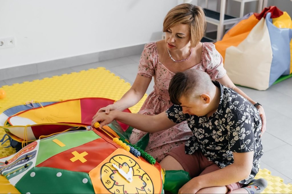 Child with disabilities doing sensory play in occupational therapy.