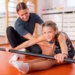Girl doing back and hamstring flexion in physical therapy
