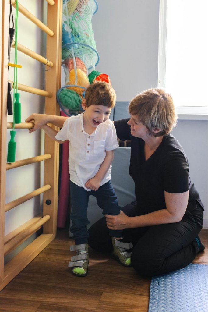 Young boy with cerebral palsy doing physical therapy exercises.