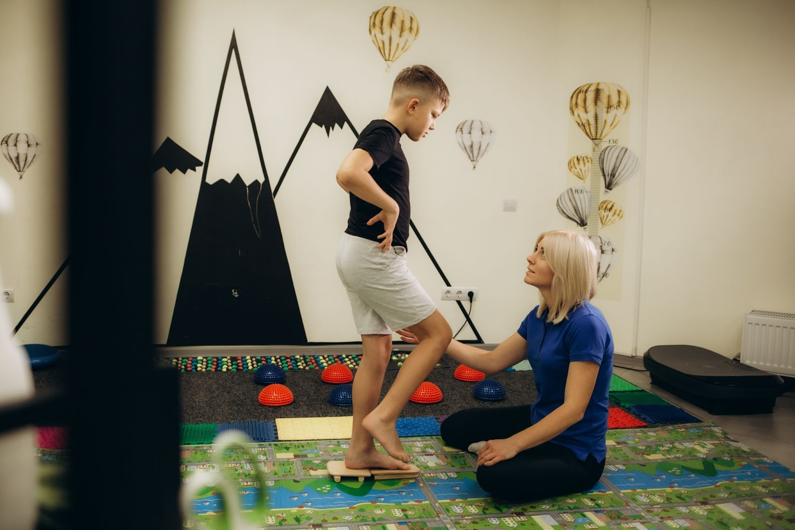 Child walking on a sensory massage mat to enhance tactile input and balance.